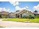 Charming single-Gathering home showcasing a well-manicured lawn and gray exterior paint at 4222 Juliana Lake Dr, Auburndale, FL 33823