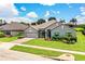 Well-maintained single-Gathering home with lush green lawn, tidy landscaping and a paved driveway at 4222 Juliana Lake Dr, Auburndale, FL 33823