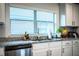 Close-up of the kitchen sink, granite countertop, and stainless steel dishwasher at 4222 Juliana Lake Dr, Auburndale, FL 33823