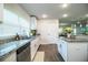 Bright kitchen view showcasing the granite countertops and stainless steel dishwasher at 4222 Juliana Lake Dr, Auburndale, FL 33823