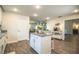Kitchen island with granite countertop and white cabinets in an open floor plan at 4222 Juliana Lake Dr, Auburndale, FL 33823