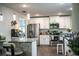 Open-concept kitchen with stainless steel appliances, granite counters, and breakfast bar seating at 4222 Juliana Lake Dr, Auburndale, FL 33823