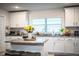 Bright kitchen with white cabinets, granite countertops, and stainless steel appliances and central island at 4222 Juliana Lake Dr, Auburndale, FL 33823