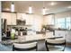 Well-lit kitchen features granite counters, stainless appliances, white cabinets and center island at 4222 Juliana Lake Dr, Auburndale, FL 33823
