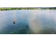 Expansive lake view featuring a small boat and serene water, emphasizing recreational opportunities at 4222 Juliana Lake Dr, Auburndale, FL 33823