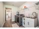Functional laundry area featuring modern appliances, a sink with storage, and convenient access to other rooms at 4222 Juliana Lake Dr, Auburndale, FL 33823