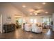 Bright, open living space with view to dining room, featuring wood-look tile and comfortable seating at 4222 Juliana Lake Dr, Auburndale, FL 33823