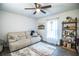 Inviting living room with a comfortable sofa, a ceiling fan, and stylish shelving at 4222 Juliana Lake Dr, Auburndale, FL 33823
