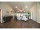 Spacious living area flowing into dining and kitchen with wood-look floors and bright lighting at 4222 Juliana Lake Dr, Auburndale, FL 33823