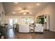 Cozy living room with high ceilings, wood-look floors, with comfortable sofa and accent chair at 4222 Juliana Lake Dr, Auburndale, FL 33823