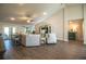 Bright living room featuring high ceilings, wood-look tile floors, and comfortable seating arrangement at 4222 Juliana Lake Dr, Auburndale, FL 33823