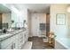 A main bathroom offering double sinks, a soaking tub, a glass shower, and luxury vinyl plank flooring at 4222 Juliana Lake Dr, Auburndale, FL 33823