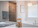 A luxurious main bathroom featuring a soaking tub with a decorative chandelier and a glass-enclosed shower at 4222 Juliana Lake Dr, Auburndale, FL 33823