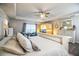 A calming main bedroom with a tray ceiling, sitting area, wood-look floors, and a personal sauna at 4222 Juliana Lake Dr, Auburndale, FL 33823