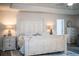 A charming main bedroom featuring a weathered white bedframe and luxury vinyl plank flooring at 4222 Juliana Lake Dr, Auburndale, FL 33823