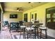 Covered patio showcasing comfortable seating, outdoor tv, and ceiling fans, perfect for entertaining at 4222 Juliana Lake Dr, Auburndale, FL 33823