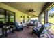 Comfortable screened patio featuring cozy seating, ceiling fans, and tranquil views of the surrounding landscape at 4222 Juliana Lake Dr, Auburndale, FL 33823