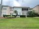 Rear view of the townhome, showcasing a private screened lanai and lush green lawn at 443 Enclave Pl # 0, Lakeland, FL 33803