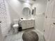 This bathroom features a tiled floor, a round mirror, and a white vanity at 443 Enclave Pl # 0, Lakeland, FL 33803