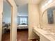 Bright bathroom with wood floor, and a view looking into the Primary bedroom through the doorway at 443 Enclave Pl # 0, Lakeland, FL 33803