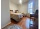 Comfortable guest bedroom with two twin beds, shuttered window, and wooden desk at 443 Enclave Pl # 0, Lakeland, FL 33803