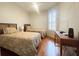 Comfortable guest bedroom with two twin beds, shuttered window, and wooden desk at 443 Enclave Pl # 0, Lakeland, FL 33803