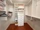 Walk-in closet featuring custom built-in shelving and drawers for optimal organization at 443 Enclave Pl # 0, Lakeland, FL 33803