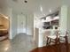 Open-concept kitchen and entryway with barstool seating for easy entertaining at 443 Enclave Pl # 0, Lakeland, FL 33803