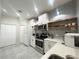 Modern kitchen featuring stainless steel appliances, quartz countertops, and floating shelves at 443 Enclave Pl # 0, Lakeland, FL 33803