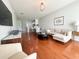 Bright living room with hardwood floors, comfortable seating, and open access to kitchen at 443 Enclave Pl # 0, Lakeland, FL 33803