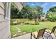 Well-manicured backyard with a lush lawn, flowerbeds, stone walkway, and mature trees at 451 Village Sw Cir, Winter Haven, FL 33880