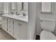 Bathroom with a double vanity and dark wood vinyl floors at 451 Village Sw Cir, Winter Haven, FL 33880