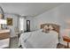 Cozy bedroom featuring wood-look floors, neutral walls, and ample natural light at 451 Village Sw Cir, Winter Haven, FL 33880