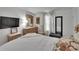 Bedroom features a calm ambiance with neutral walls, wood-look flooring, and ample natural light at 451 Village Sw Cir, Winter Haven, FL 33880