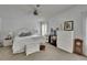 Serene bedroom with white furnishings, fan, and ample natural light at 451 Village Sw Cir, Winter Haven, FL 33880