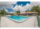 Beautiful community pool with ample seating and mature trees at 451 Village Sw Cir, Winter Haven, FL 33880
