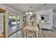 Inviting dining area with sliding glass doors to lanai, wood-look floors, and natural light at 451 Village Sw Cir, Winter Haven, FL 33880