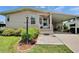 Inviting home entrance featuring a manicured garden and covered parking at 451 Village Sw Cir, Winter Haven, FL 33880