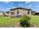 Exterior home view showcasing a well-maintained yard and central air conditioning unit at 451 Village Sw Cir, Winter Haven, FL 33880