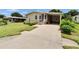 Charming single-story home with a well-maintained lawn and a convenient carport at 451 Village Sw Cir, Winter Haven, FL 33880