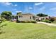 Charming single-story home with a well-maintained lawn and mature landscaping at 451 Village Sw Cir, Winter Haven, FL 33880