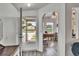 Bright foyer featuring wood-look flooring and an open view to the outdoors at 451 Village Sw Cir, Winter Haven, FL 33880
