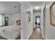 Hallway leading to bedroom with wood-look floors and neutral walls at 451 Village Sw Cir, Winter Haven, FL 33880