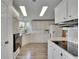 Bright kitchen with white cabinets, modern appliances, and ample counter space at 451 Village Sw Cir, Winter Haven, FL 33880