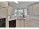 Kitchen area with corner sink, dishwasher, and bright lighting at 451 Village Sw Cir, Winter Haven, FL 33880