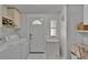 Bright laundry area featuring washer, dryer, storage, and access to the outside at 451 Village Sw Cir, Winter Haven, FL 33880