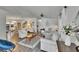 Spacious living room featuring wood-look floors and neutral walls, seamlessly connecting to the dining area at 451 Village Sw Cir, Winter Haven, FL 33880