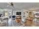 Bright living room with wood-look floors, neutral walls, and an open layout with dining area at 451 Village Sw Cir, Winter Haven, FL 33880