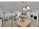 An open living space with dining area, a chandelier and abundant natural light at 451 Village Sw Cir, Winter Haven, FL 33880