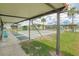 Covered outdoor shuffleboard court with lush greenery, benches, and palm trees at 451 Village Sw Cir, Winter Haven, FL 33880